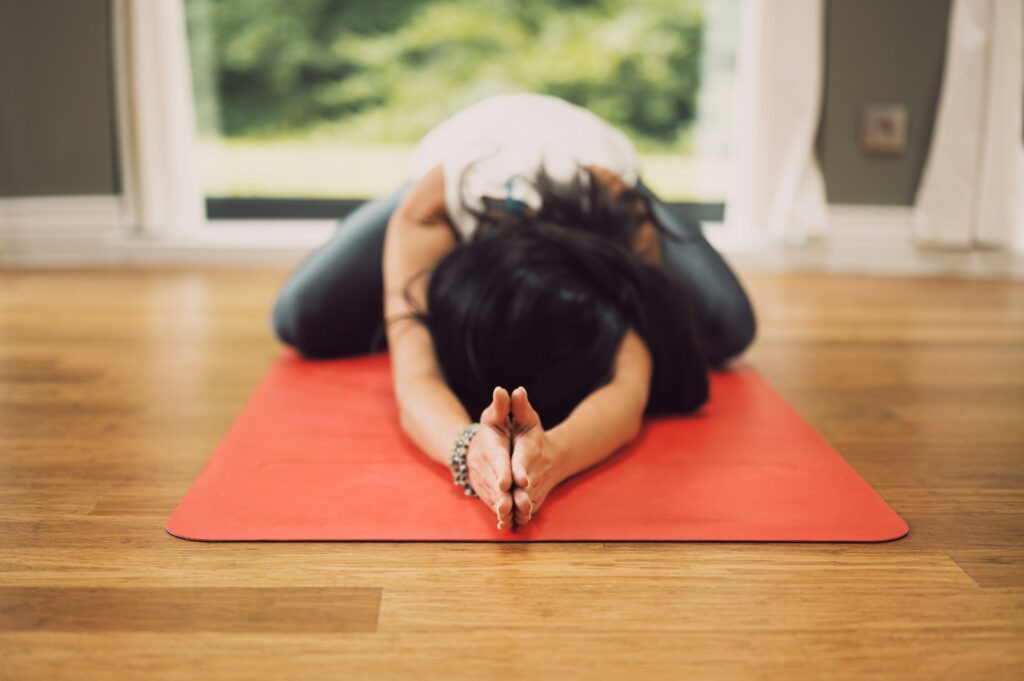 A person practicing restorative yoga.