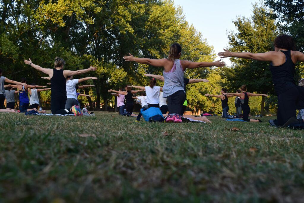 a group of women doing yoga outdoors
